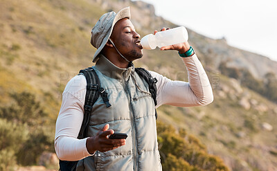 Buy stock photo Hiking, water bottle and black man with a smartphone, connection and hydration with fitness. African person, guy or hiker with a cellphone, mountain or thirsty with health, network or drinking liquid