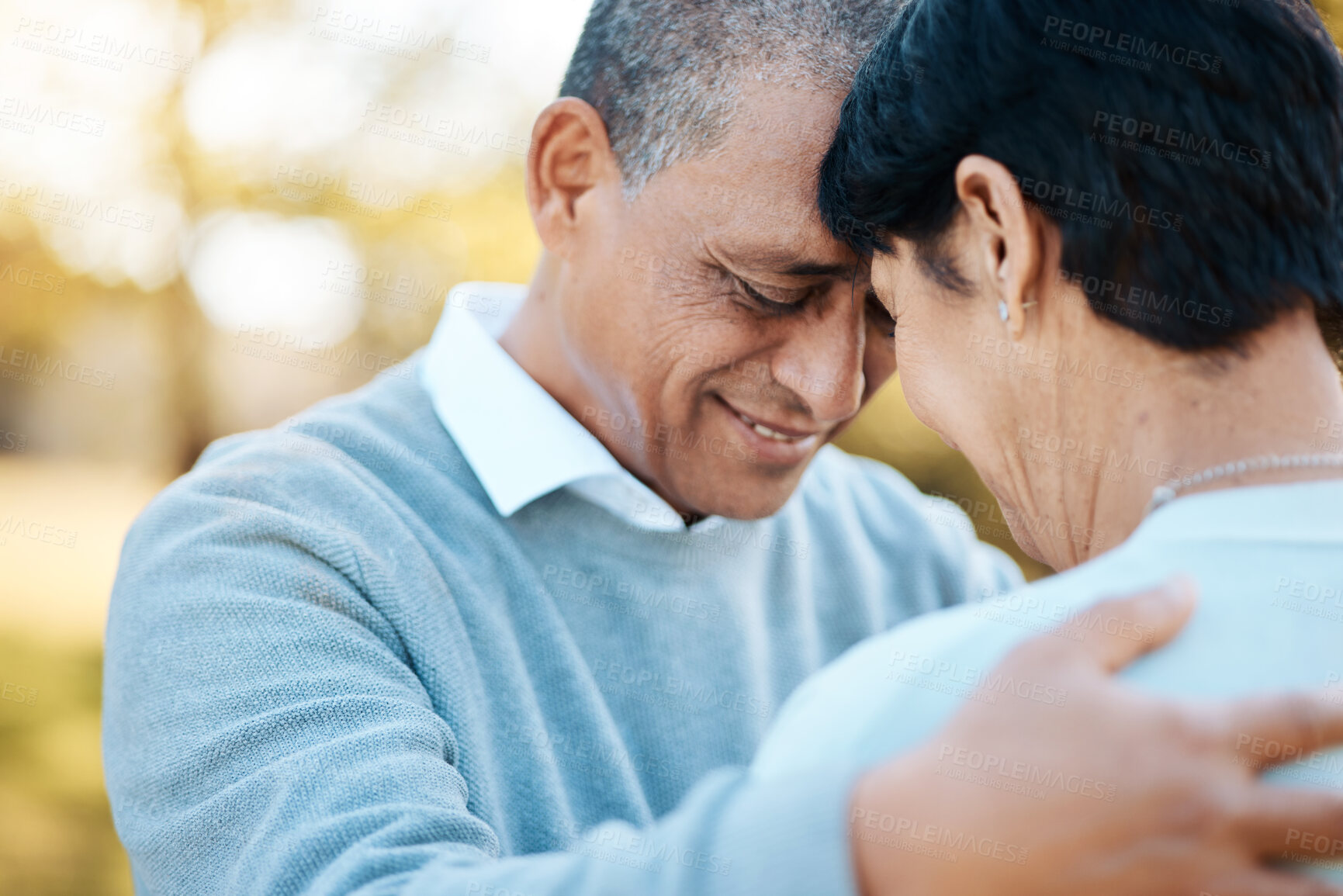 Buy stock photo Happy, connection and senior couple hugging in a park on an outdoor date for romance, bonding or love. Smile, happiness and elderly man and woman in retirement in nature in field together at sunset.