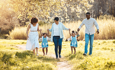 Buy stock photo Walking, holding hands and family generations in nature at an outdoor park together for bonding. Love, fun and children with grandmother and parents in a green garden on weekend trip or holiday.