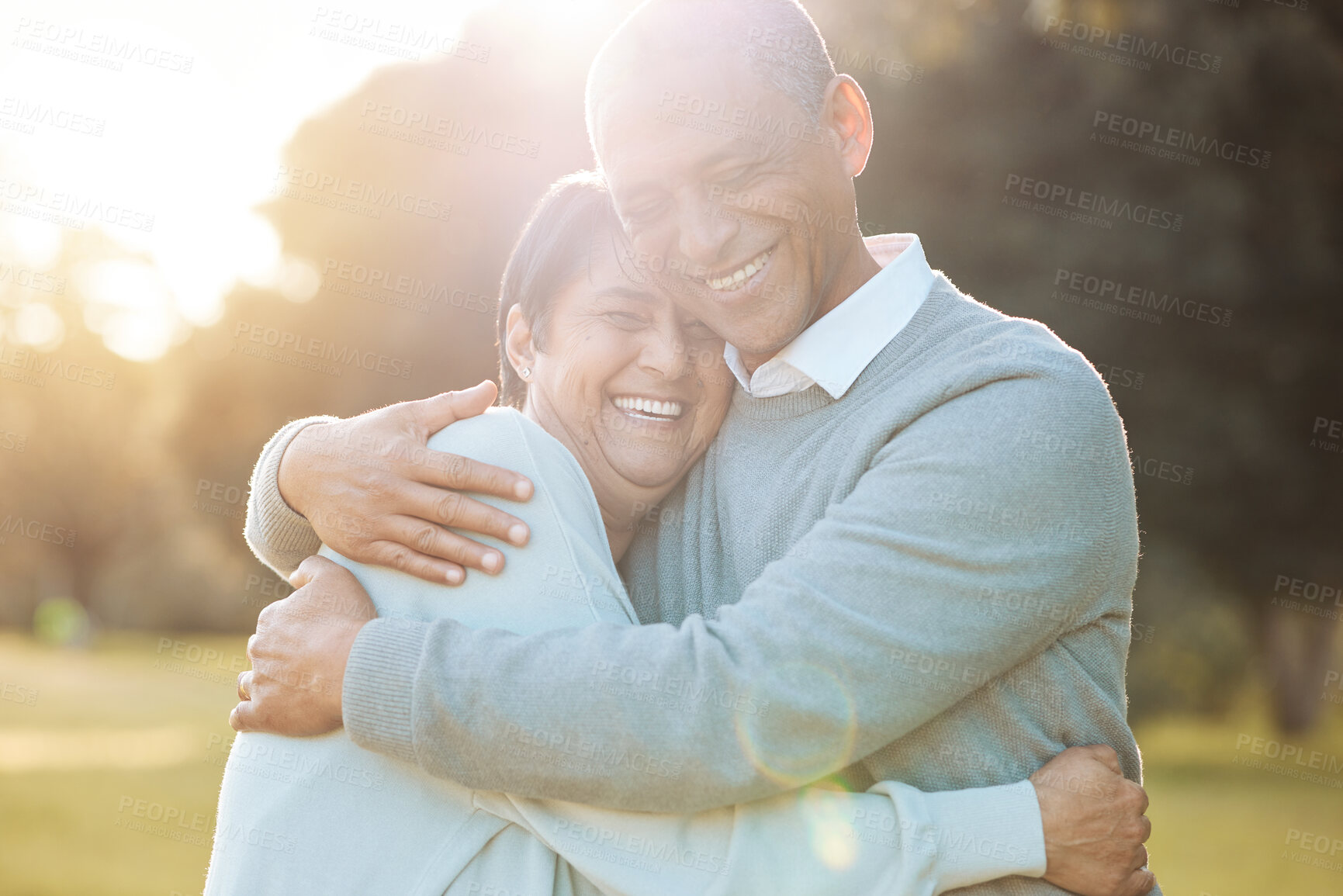 Buy stock photo Nature, smile and senior couple hugging with love, care and romance on a date in outdoor park. Happy, laughing and elderly man and woman in retirement embracing, talking and bonding together in field