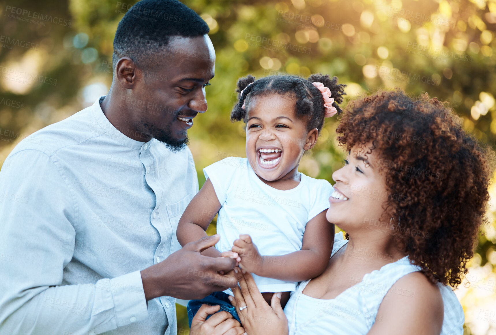 Buy stock photo Diversity, love and children with a family laughing outdoor in a garden together for support, comedy or bonding. Kids, smile or kids with a happy mother, father and daughter in a park during summer