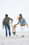 Family, beach and holding hands of a child outdoor with fun energy, happiness and love in nature. Man and woman or parents playing with a girl kid on holiday, adventure or vacation at sea with banner