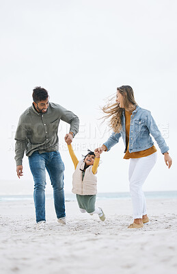 Buy stock photo Family, beach and holding hands of a child outdoor with fun energy, happiness and love in nature. Man and woman or parents playing with a girl kid on holiday, adventure or vacation at sea with banner