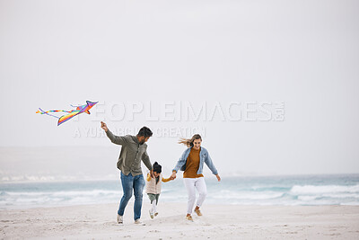 Buy stock photo Family, running and flying a kite at beach outdoor with fun energy, happiness and love in nature. Man and woman playing with a girl kid on holiday, freedom adventure or vacation at sea with banner