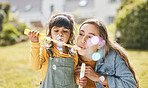Family, mother and girl child blowing bubbles together on grass in nature for picnic, happiness and love. Summer, woman and kid in park or playground for play, freedom and quality time with care 