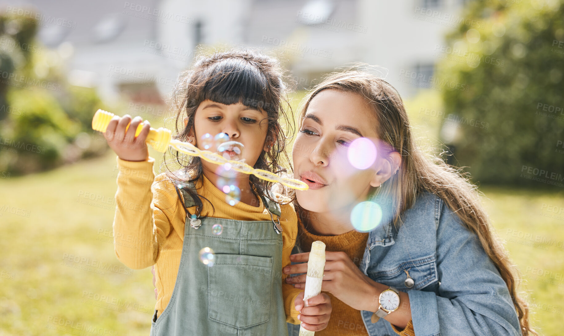 Buy stock photo Mother and girl child blowing bubbles together on grass in nature for picnic, happiness and love. Summer, woman and kid in park or playground for family play, freedom and quality time with care 