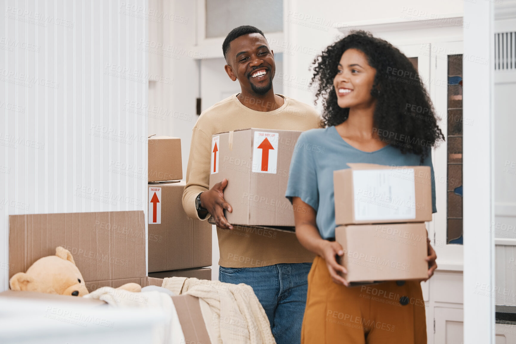 Buy stock photo Happy black couple, box and moving in new home, property or investment together in happiness. African man and woman smile with boxes in renovation, relocation or house mortgage and apartment loan