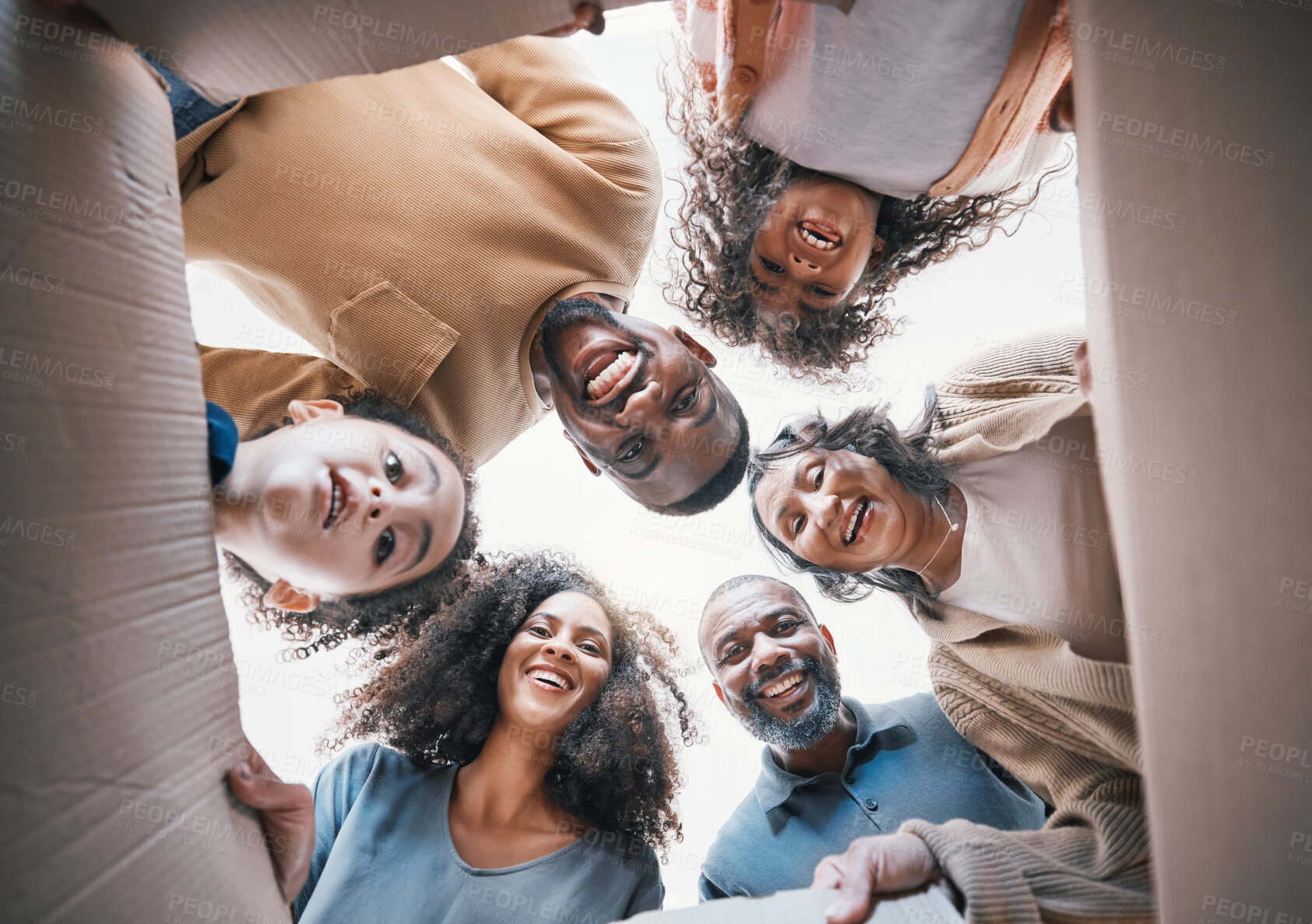 Buy stock photo Family, open box and smile from below in portrait, circle or excited for present, gift or moving together in home. Happy, group or parents giving children and grandparents a package and parcel