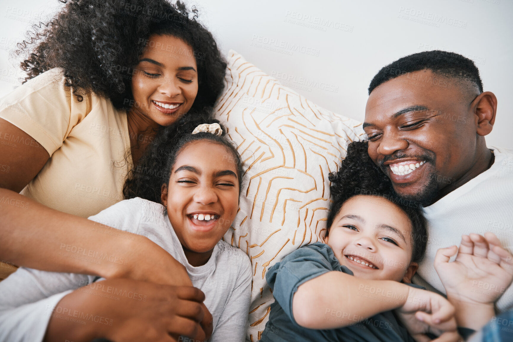 Buy stock photo Mom, dad and kids in bed with tickling, comic joke and laugh with bonding, care and love in family home. Black man, mother and daughter with smile, playful game and crazy in bedroom, morning or house