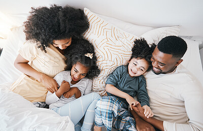 Buy stock photo Mom, father and kids in bed with tickling, comic joke and laugh in top view, care and love in family house. Black man, mother and daughter with smile, play game and crazy in bedroom, morning and home