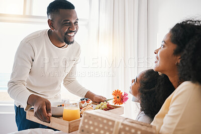 Buy stock photo Mothers day, breakfast and family in bed with happy dad, mom and child together in home with love, care and brunch tray. Father, surprise and mom with girl and food in bedroom for special celebration