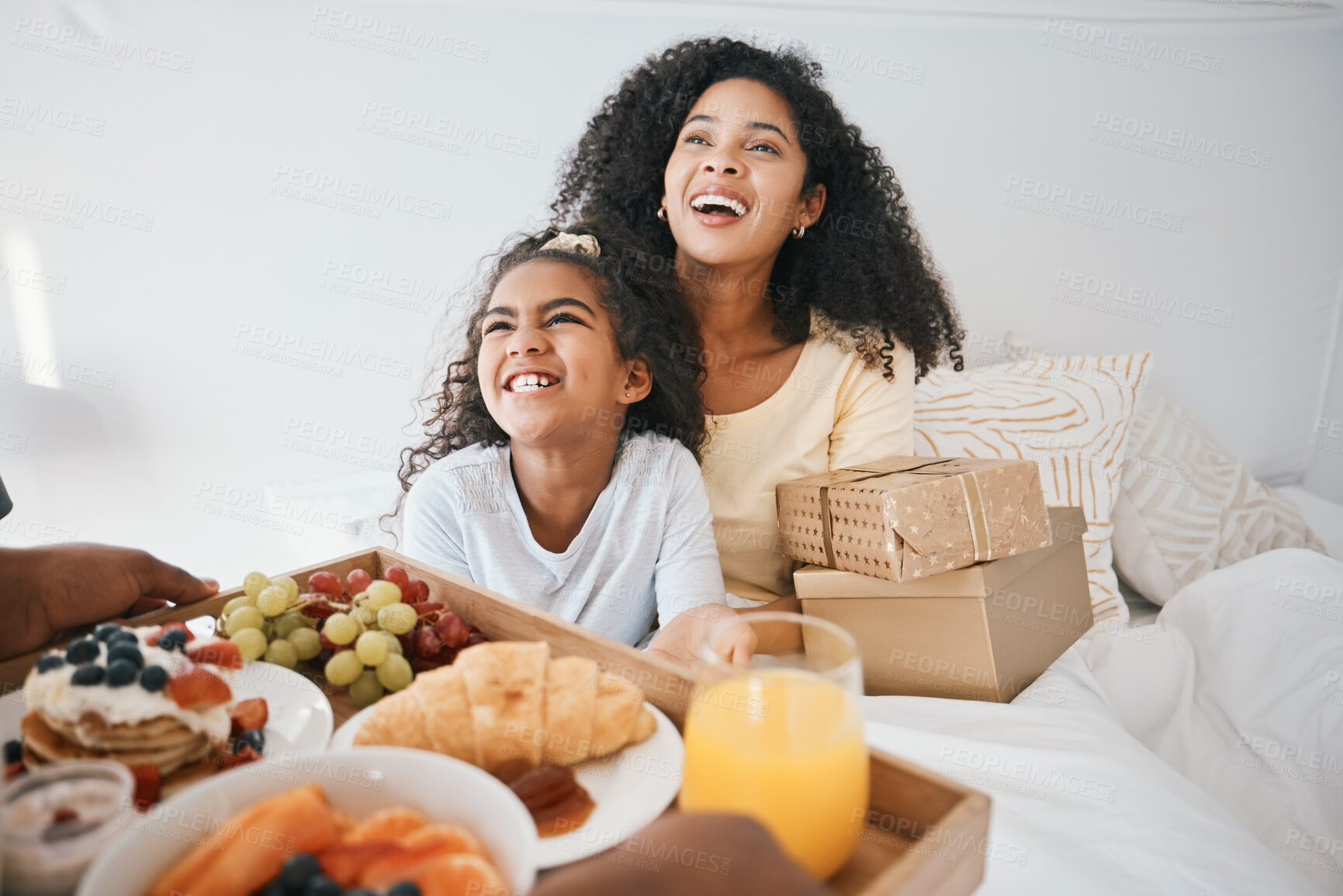 Buy stock photo Breakfast, mothers day and child with mom in bed to relax for eating healthy, nutrition and diet. Happy, smile and young woman with girl kid in bedroom with gifts, presents and food at family home.