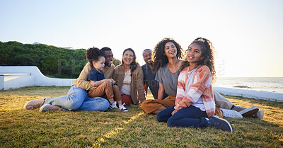 Buy stock photo Beach, smile and family relax on vacation, bonding and having fun together on grass on mockup space. Grandparents, happy and interracial parents with kids at ocean to travel on holiday, care and love