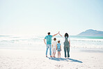 Family, beach and summer vacation on mockup in travel, outdoor holiday or together on sunny day. Rear view of father, mother and children on ocean coast for fun day, bonding or break at sea in nature