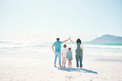 Family, beach and summer vacation on mockup in travel, outdoor holiday or together on sunny day. Rear view of father, mother and children on ocean coast for fun day, bonding or break at sea in nature