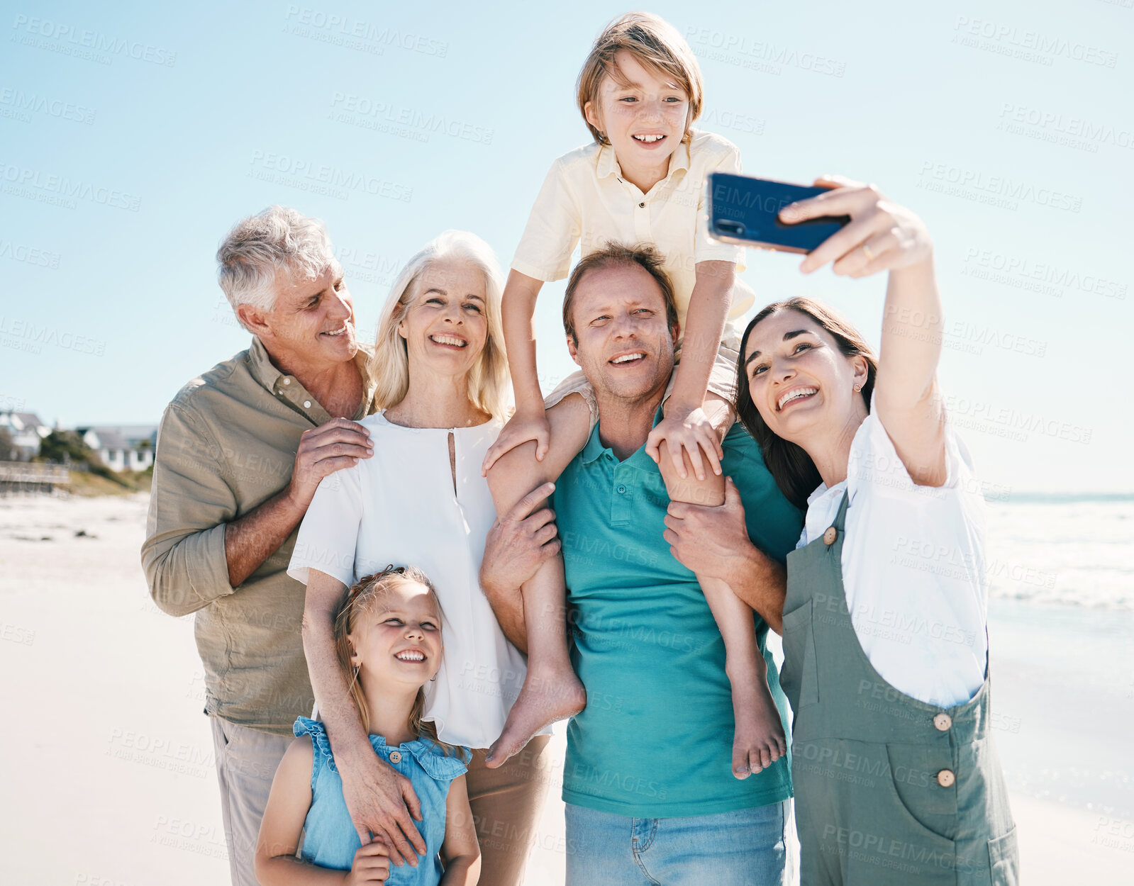 Buy stock photo Parents, grandparents and kids in beach selfie, smile or bonding for love, sunshine or memory on vacation. Men, women and children by sea, waves or happy with social media post for summer in Spain