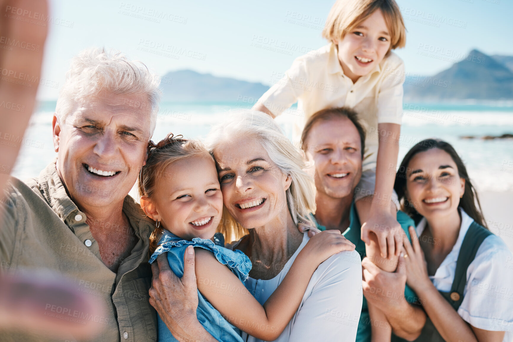 Buy stock photo Family, grandparents and children in beach selfie, portrait or parents for love, sunshine or memory on holiday. Men, women and kids by sea, happy and update on social network post for summer in Spain