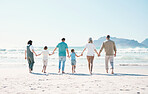 Relax, travel and holding hands with big family on the beach for support, summer vacation or bonding. Freedom, health and love with people walking on seaside holiday for adventure, trust or happiness