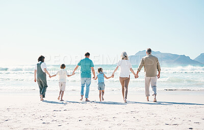 Buy stock photo Relax, travel and holding hands with big family on the beach for support, summer vacation or bonding. Freedom, health and love with people walking on seaside holiday for adventure, trust or happiness