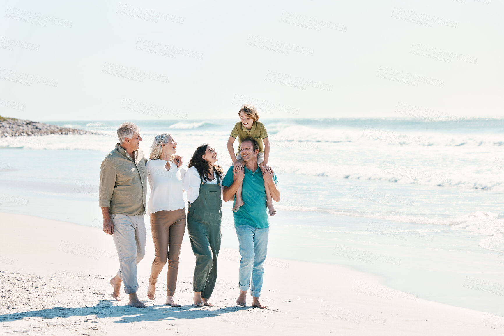 Buy stock photo Relax, travel and walking with big family on the beach for support, summer vacation or bonding. Freedom, health and love with people on seaside holiday for adventure, trust or happiness together