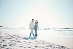 Beach, happy couple walking and holding hands on vacation, care and bonding in summer on mockup space. Man, woman and smile at ocean to travel, romance or support love in relationship together at sea