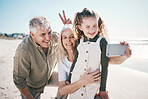 Family, selfie and beach holiday with peace sign, grandparents and young girl with a smile. Happy, child and portrait at the sea and ocean with a profile picture for social media on summer vacation 