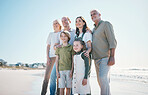 Grandparents, kids and big family with smile at beach, hug or bonding for love, sunshine or excited on vacation. Men, women and children by sea, waves or happy embrace for holiday for summer in Spain