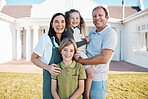 Happy family, portrait and real estate in new home, property or investment on outdoor grass or lawn. Mother, father and kids smile for moving in, house or bonding in happiness or embrace together