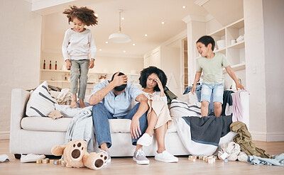 Buy stock photo Headache, chaos and parents on sofa with children jumping in the living room of family house. Stress, burnout and kids playing in the lounge with blur motion and young mom and dad at home in Mexico.