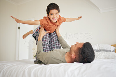 Buy stock photo Father, child and playing on bed, airplane or flying with freedom, happiness and bonding at family home. Love, care and man with boy are playful in bedroom, arms in air and smile for fun together