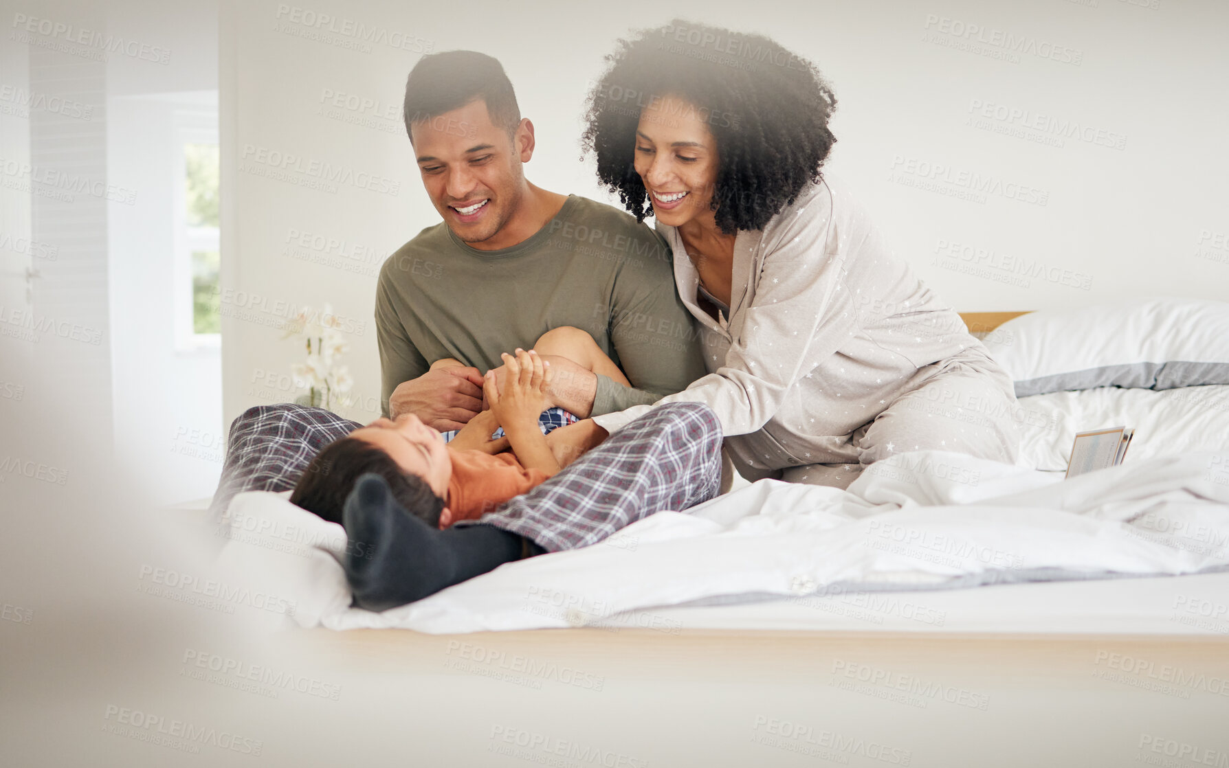 Buy stock photo Happy, family tickle and bedroom with laughing with bonding of father, mother and child smile. Home, mom and dad together with love, bonding and care in bed in morning with kid in house with parents