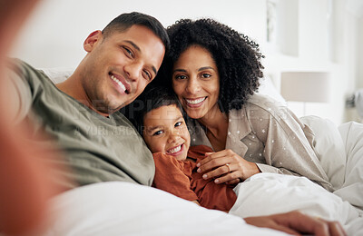 Buy stock photo Selfie, love and happy with a family in the bedroom of their home together in the morning. Portrait, smile or relax with a mother, father and son in bed on a weekend during summer vacation or holiday