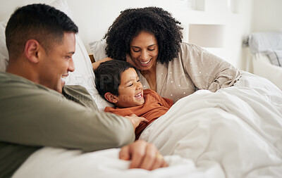 Buy stock photo Happy, family laughing and bedroom with portrait with bonding of father, mother and child. Home, mom and dad together with love, bonding and care in a bed in morning with kid in house with parents