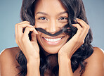 Curly hair, mustache or portrait of happy woman in studio for wellness, treatment or comedy joke. Haircare, blue background or face of model with funny pose for natural beauty, texture or keratin