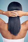 Beauty, hair and hands with a woman from the back in studio on a gray background for shampoo treatment. Keratin, spa or salon for haircare and a model closeup with natural and aesthetic growth