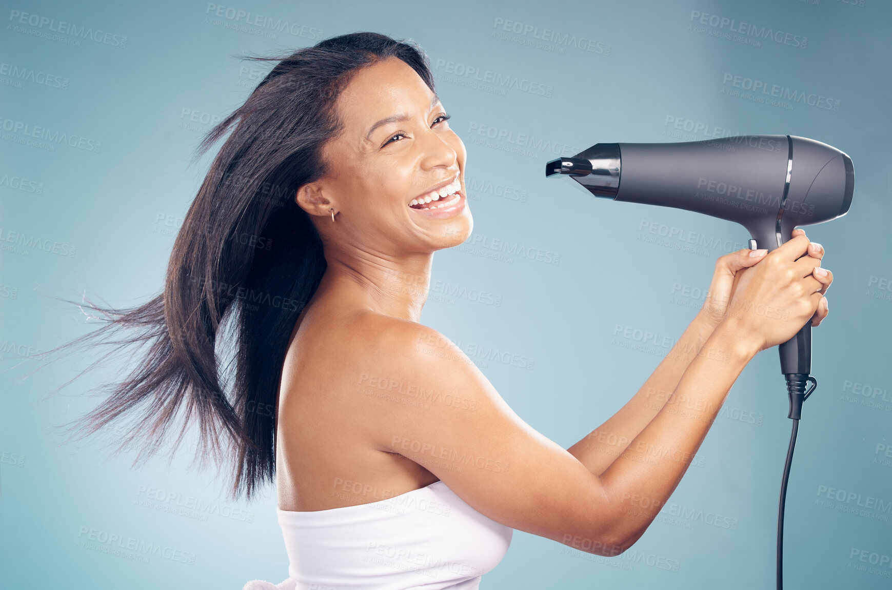 Buy stock photo Excited, woman and hairdryer for hair care in studio isolated on a blue background. Natural beauty, blow dryer air and model in healthy salon treatment, hairstyle wellness and hairdresser thinking