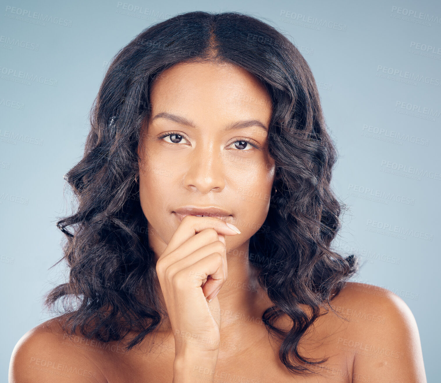 Buy stock photo Wellness, curly hair or portrait of woman in studio or salon for keratin growth, healthy shine or beauty. Thinking, texture or face of female model with natural hairstyle or glow on blue background