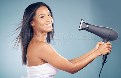 Buy stock photo Portrait, happy woman and blow dryer for hair care in studio isolated on a blue background. Face, natural beauty and hairdryer of model in healthy salon treatment, hairstyle wellness and hairdresser