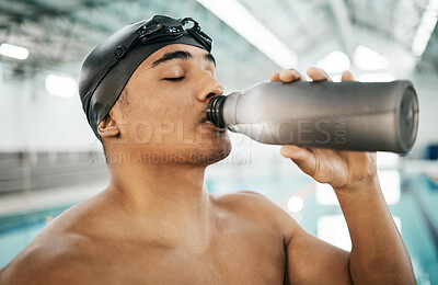 Buy stock photo Water bottle, swimming and young athlete by a pool for race, marathon or competition training. Hydration, thirsty and male swimmer drinking healthy beverage for practice, exercise or workout.