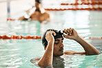 Swimming pool, man and sport athlete for workout and training race in university gym. Male person, fitness and exercise  for water competition in a health and wellness club at school for athlete