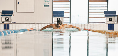 Swimming exercise, pool and sports man doing water challenge, cardio training or butterfly stroke action. Motivation, athlete and swimmer workout, practice or training for competition, match or race