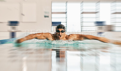 Swimming action, pool and sports man doing water challenge, cardio training or butterfly stroke action. Motivation, speed blur and swimmer workout, practice or training for competition, match or race