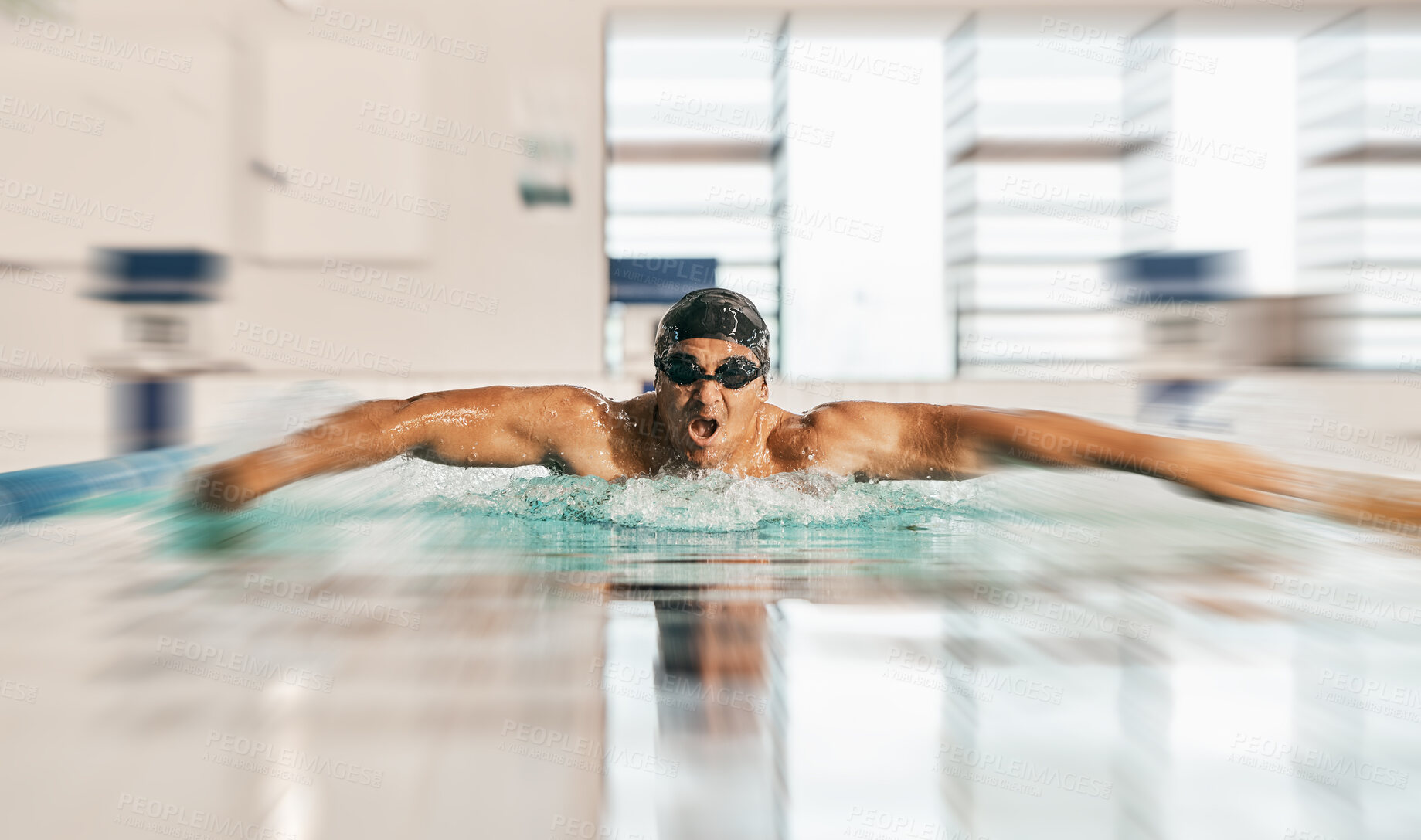 Buy stock photo Swimming action, pool and sports man doing water challenge, cardio training or butterfly stroke action. Motivation, speed blur and swimmer workout, practice or training for competition, match or race