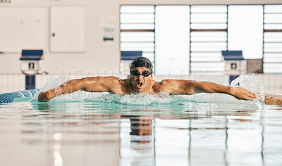 Swimming pool, water splash and sports man challenge, cardio training or butterfly stroke, action and fast motion. Motivation, commitment or swimmer workout, practice or training for competition race
