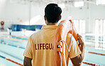 Lifeguard, back and person with swimming, pool or safety lifebuoy for rescue support, help or life saving. Surveillance attention, equipment and expert for protection, security or medical emergency 