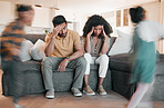 Frustrated parents, headache and children with stress in burnout, anxiety or depression in living room chaos at home. Couple, family and busy ADHD kids or siblings running around sofa in crazy house