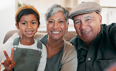 Buy stock photo Peace sign selfie, smile and a girl with her grandparents on a sofa in the living room of their home closeup. Grandmother, grandfather and granddaughter together for a photograph during a visit 