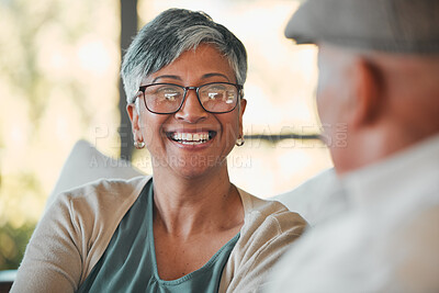 Buy stock photo Conversation, smile and senior couple on a sofa for relaxing, communication or bonding together. Happy, love and elderly woman in retirement talking to her husband in the living room of modern home.