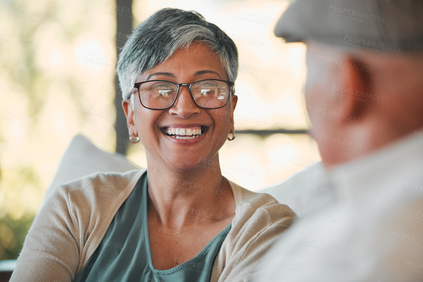 Buy stock photo Conversation, smile and senior couple on a sofa for relaxing, communication or bonding together. Happy, love and elderly woman in retirement talking to her husband in the living room of modern home.