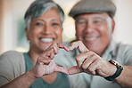 Portrait, home and senior couple with heart sign, marriage or commitment with support, care or kindness. Face, old man or elderly woman with symbol for love, trust or emoji with peace or relationship